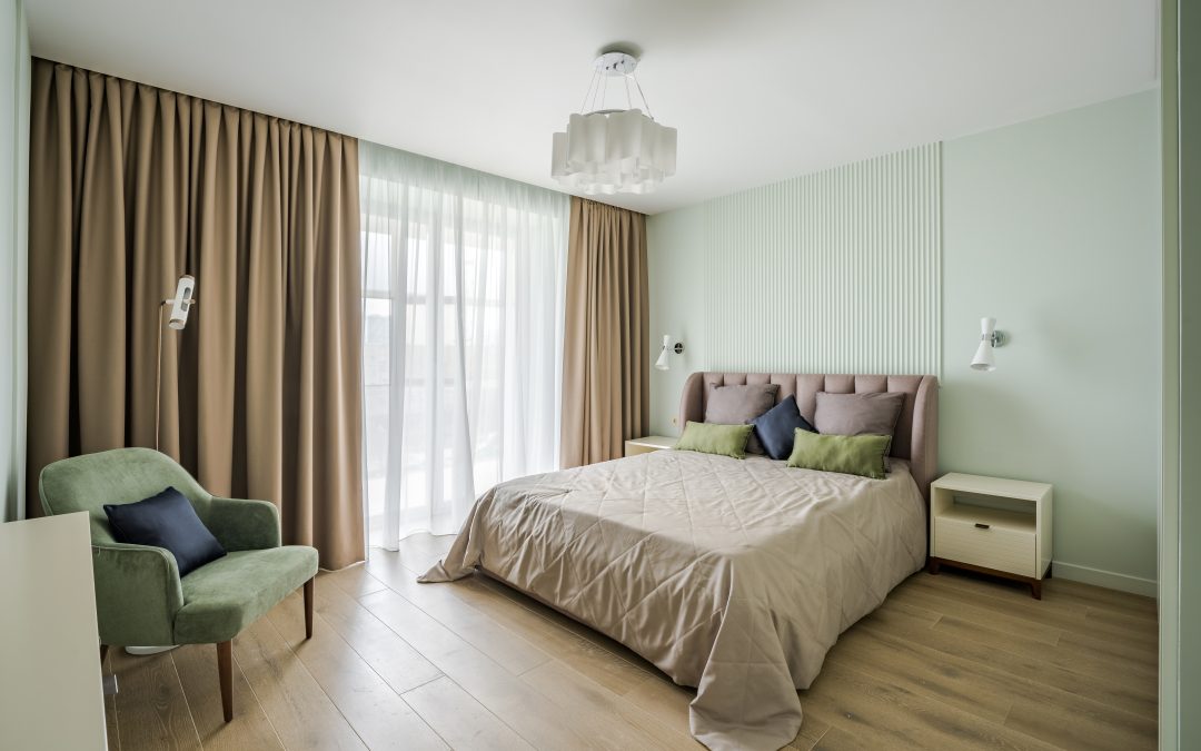 Bedroom with double bed and laminate flooring.